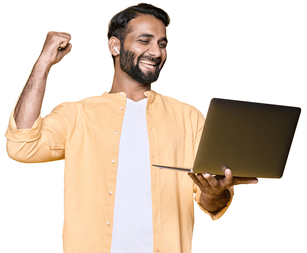 happy indian man raising fist watching game on lap QGXZNRH